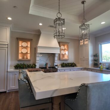 Bright kitchen with marble island and clean cabinetry serviced by Vieira Cleaning