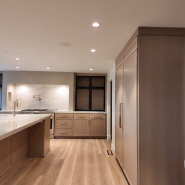 Modern light wood kitchen with clean floors and surfaces after a Vieira Cleaning service