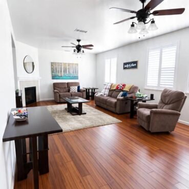 Tidy living room with polished hardwood floor cleaned by Vieira Cleaning